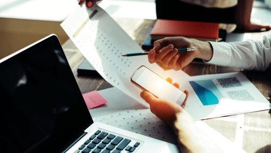 File image of laptop, phone and spreadsheet